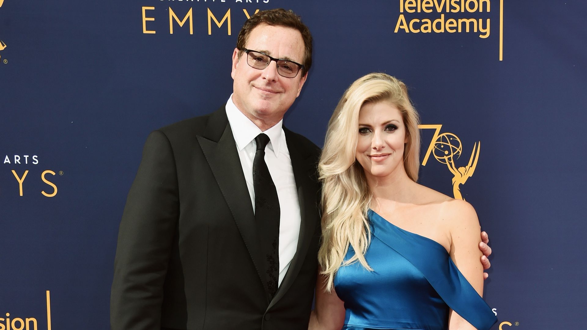 Kelly Rizzo and Bob Saget smiling at their wedding