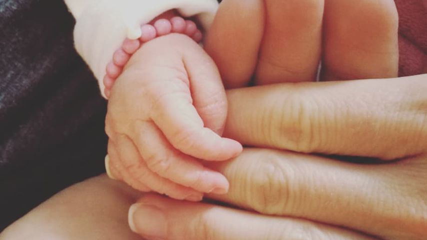 Hände von Alissa Harouat und ihrem Baby